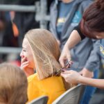 Quad Citians walk and donate hair to support kids with cancer