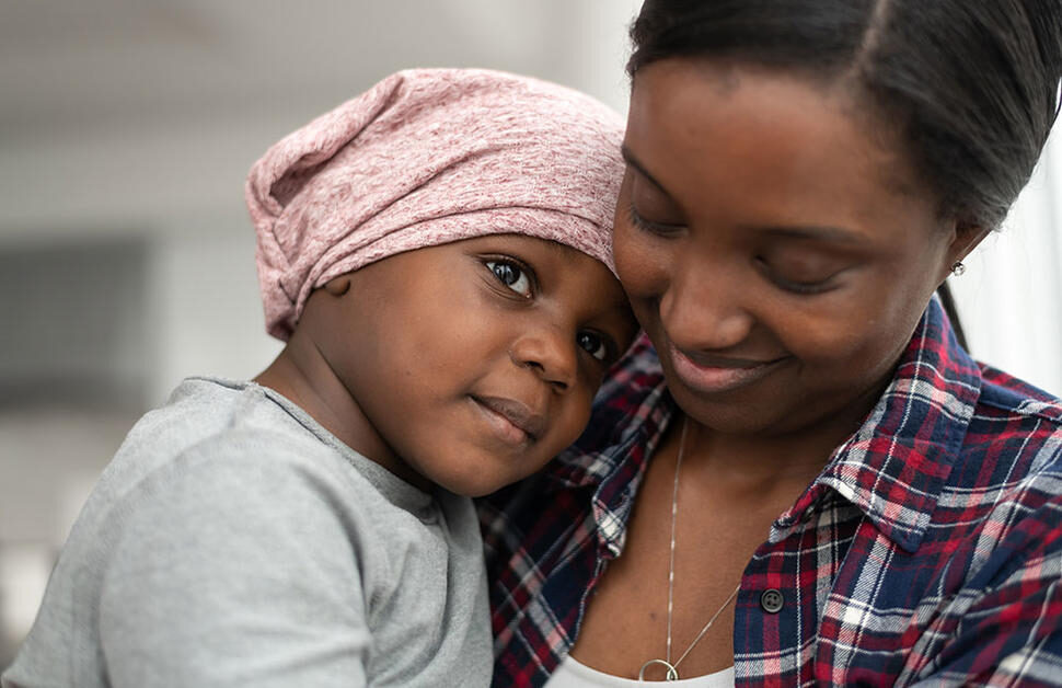 mother-of-african-descent-cuddles-her-child-who-has-cancer